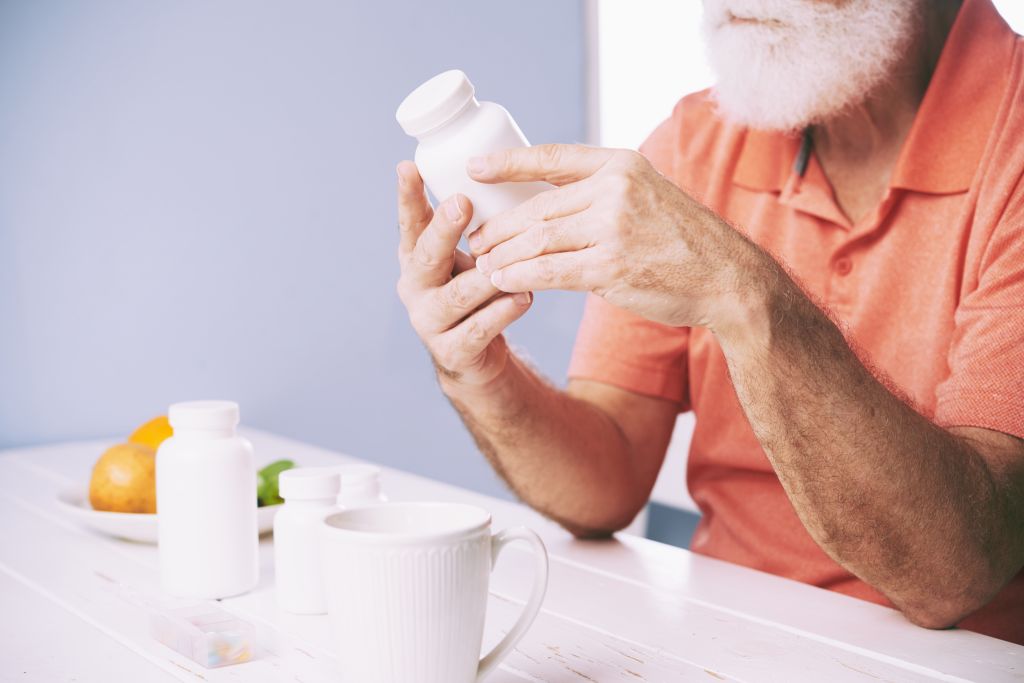 Man reading supplement label