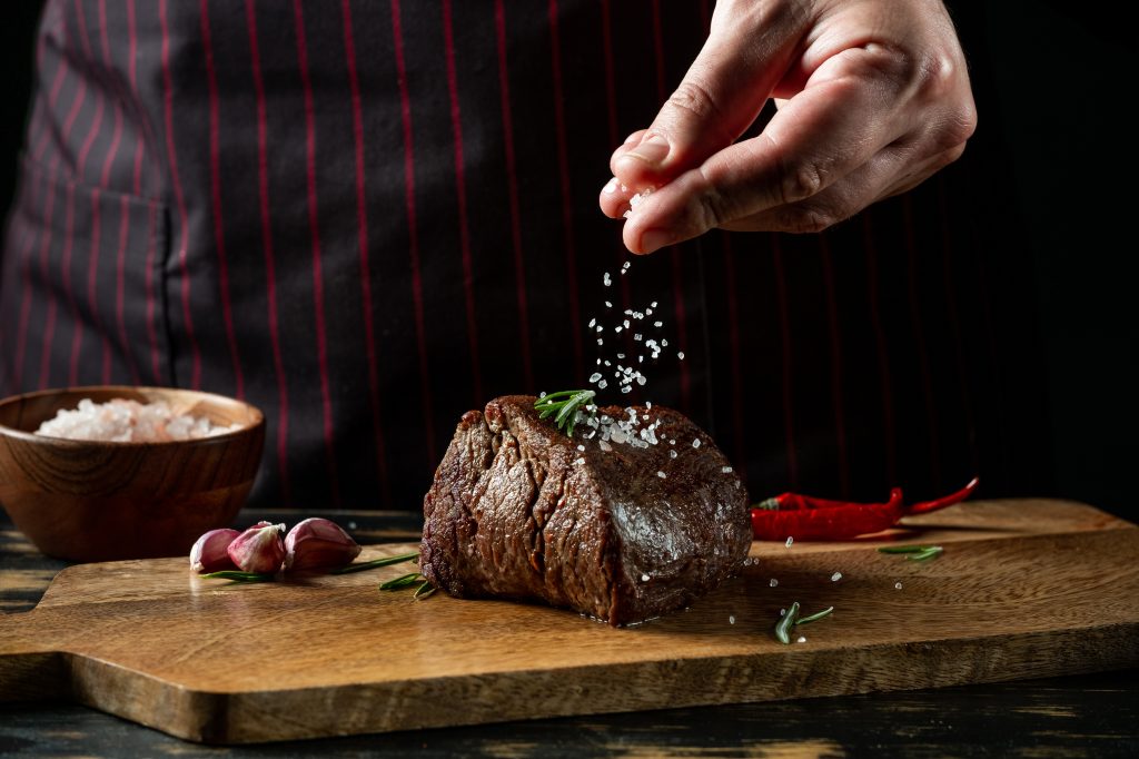 Adding salt to cooked steak