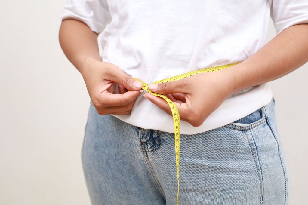 Woman measuring waist