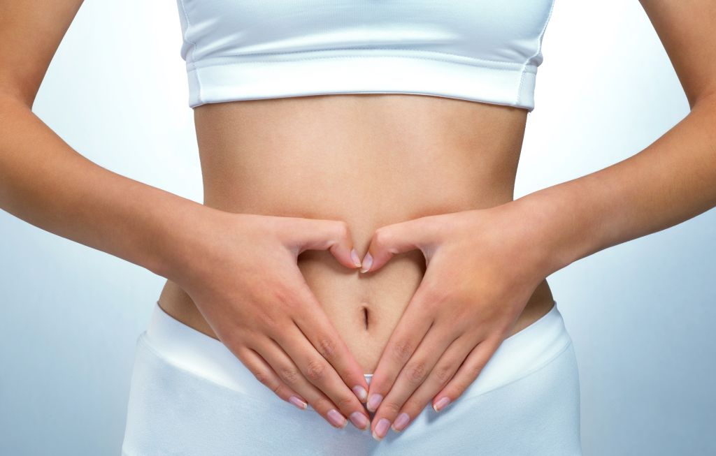 Woman with hands on stomach