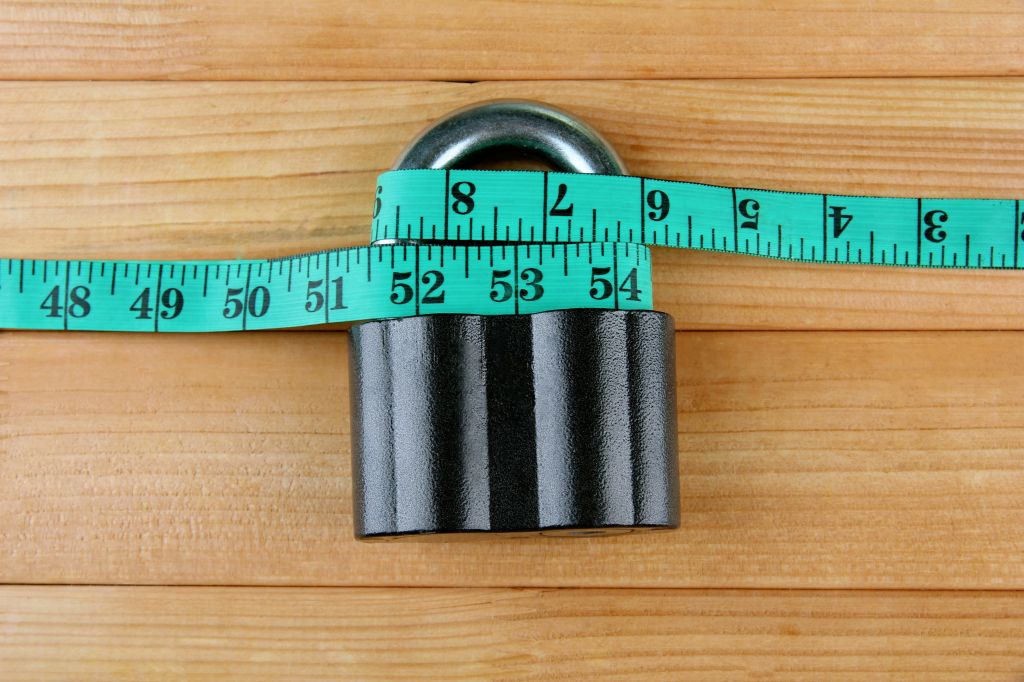 Lock with a measuring tape around it