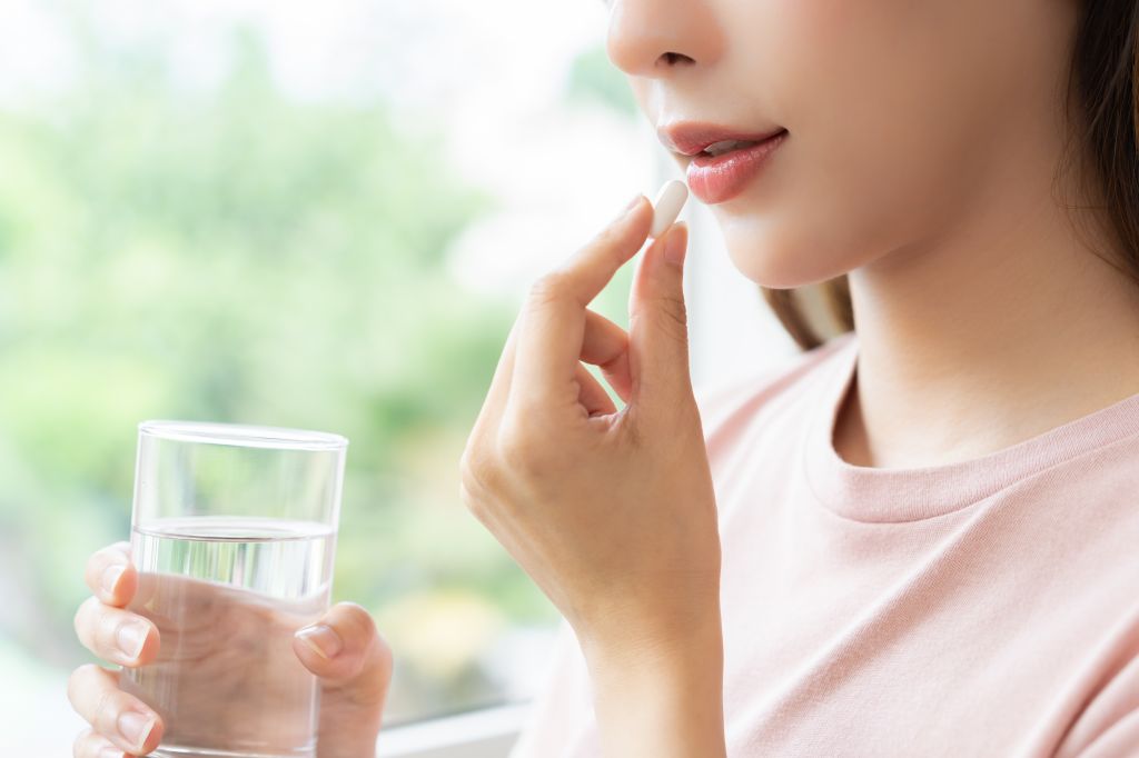 Woman taking a supplement