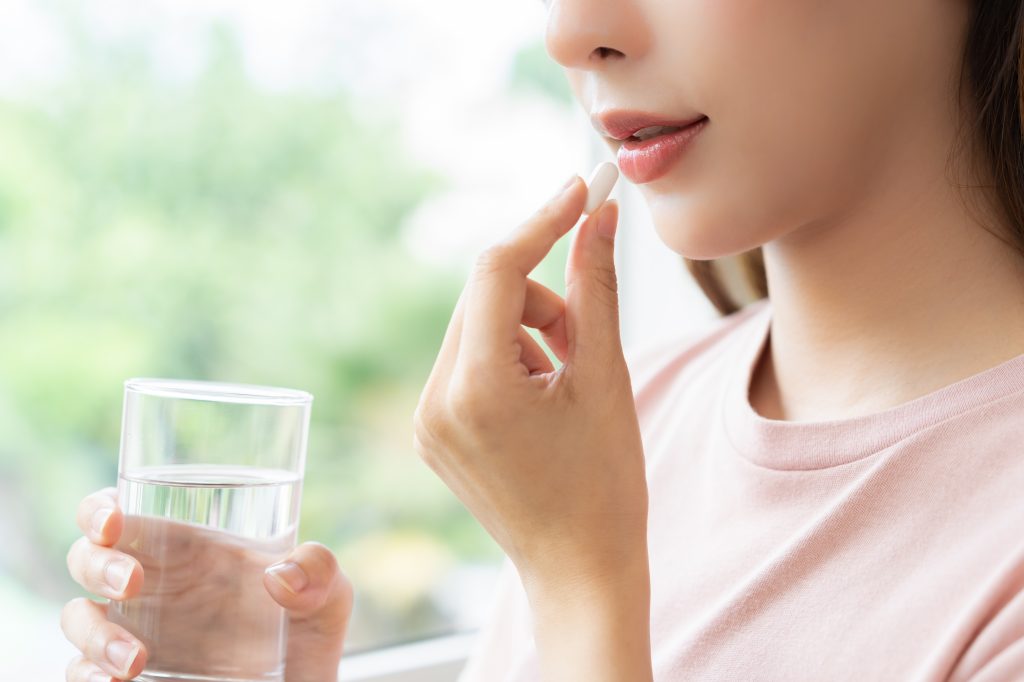 Woman taking a supplement