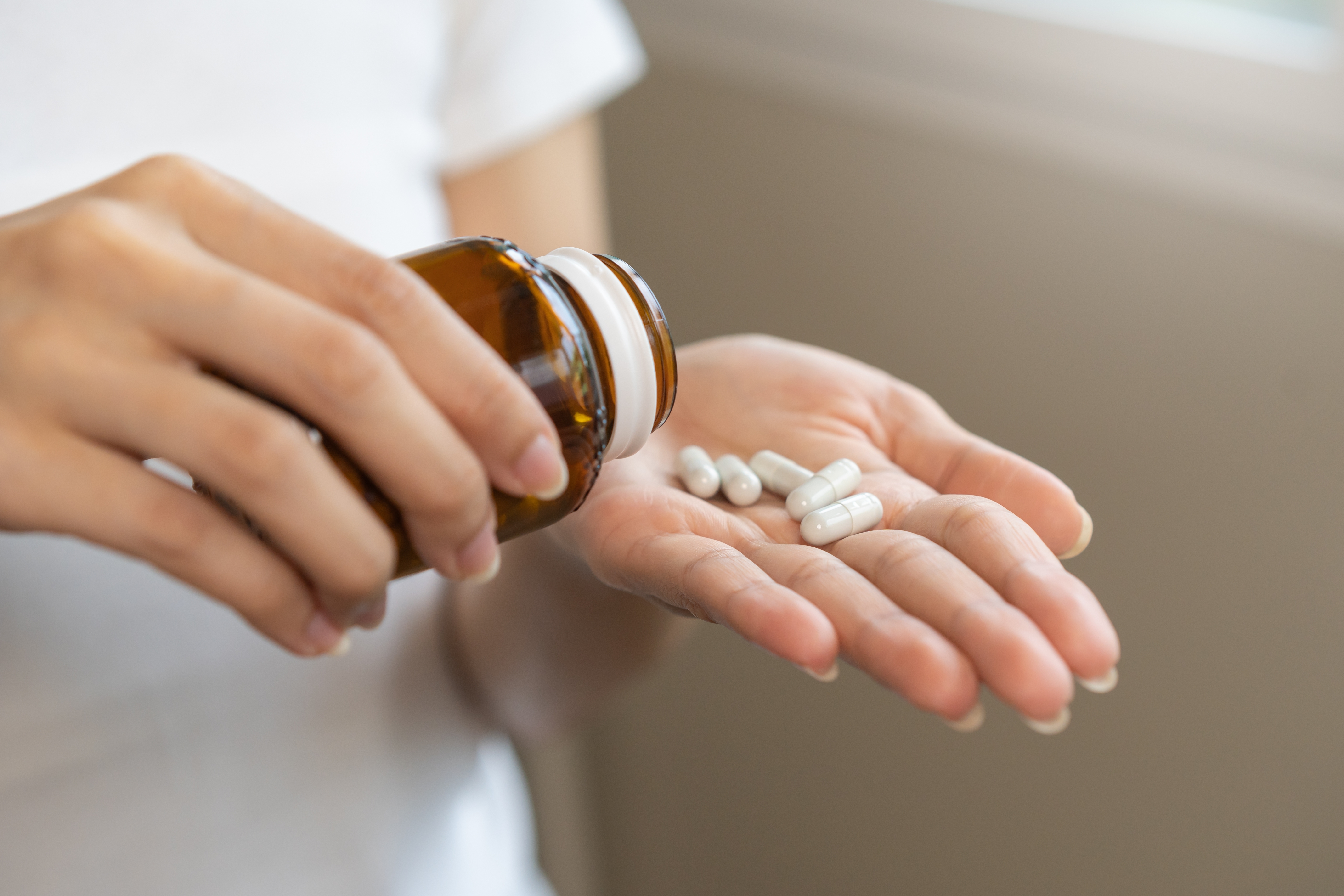 Woman taking dietary supplement