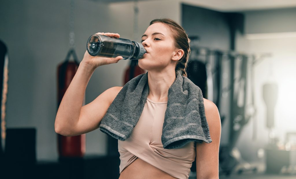 Women drinking water in gym