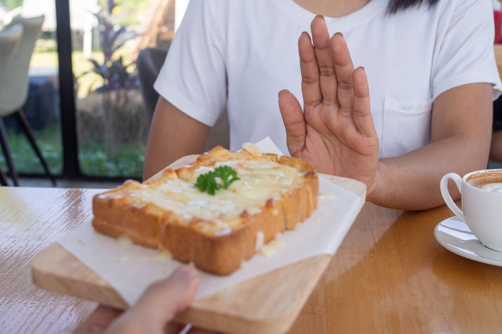 Woman declining cheese bread  