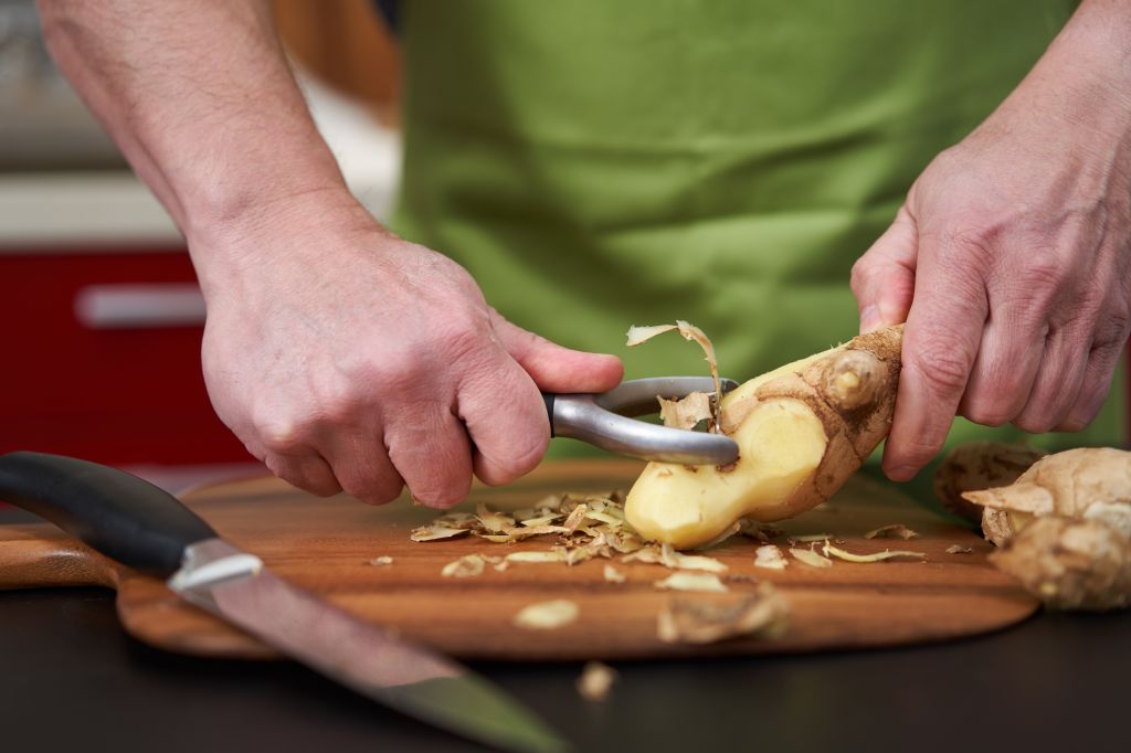Man peeling ginger 