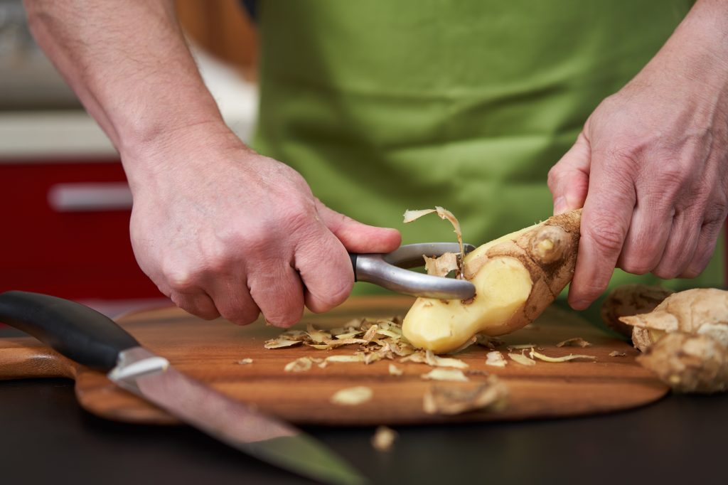 Man peeling ginger