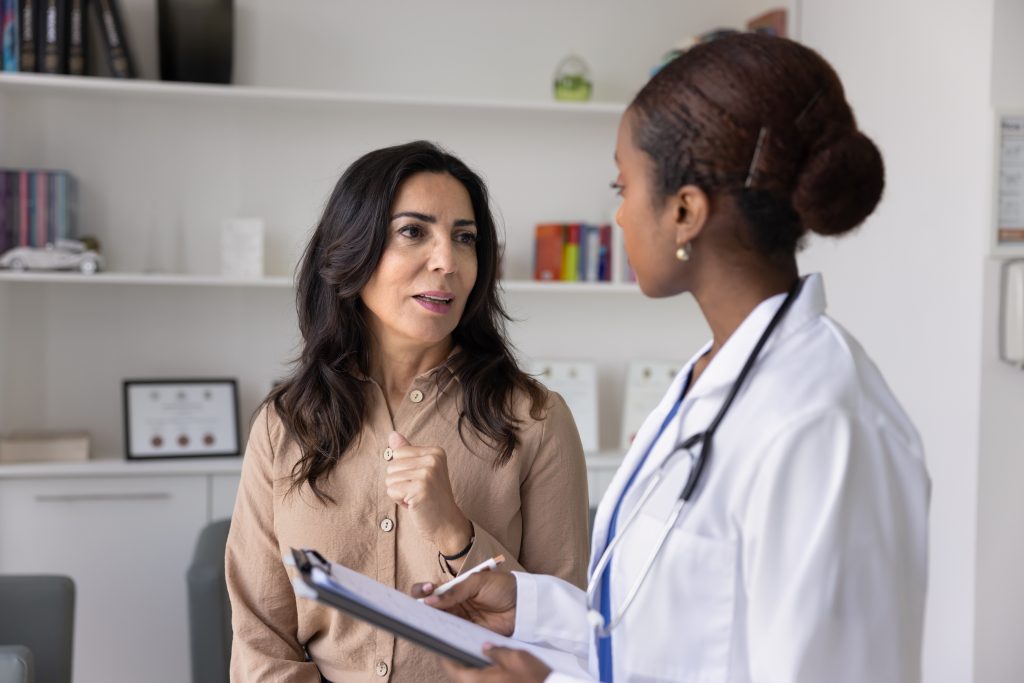 Woman talking to doctor