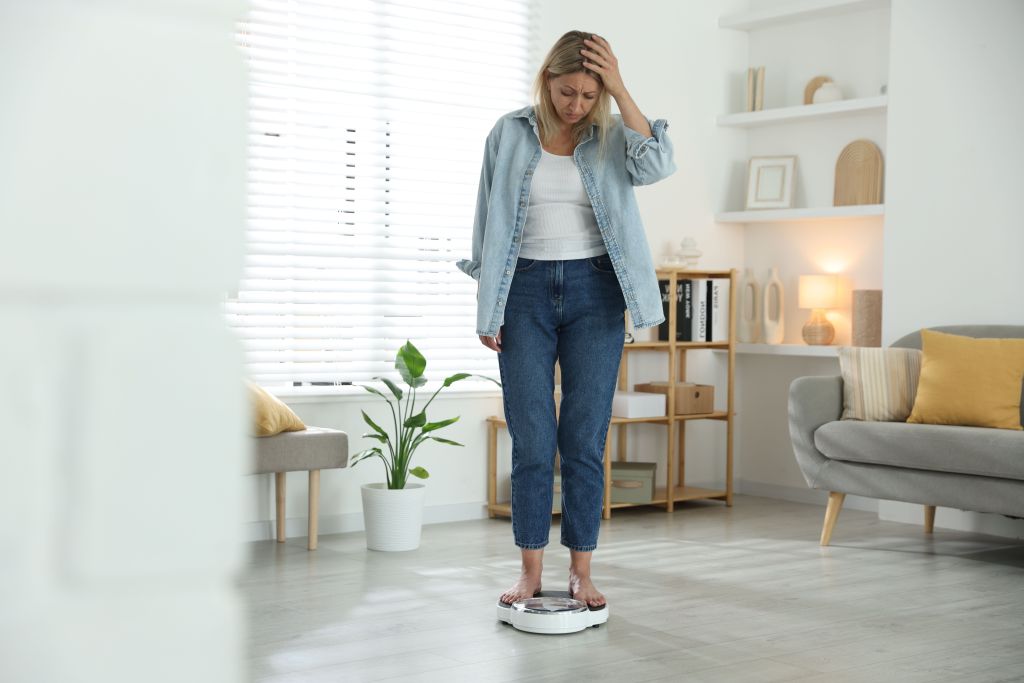 Woman experiencing weight gain from menopause