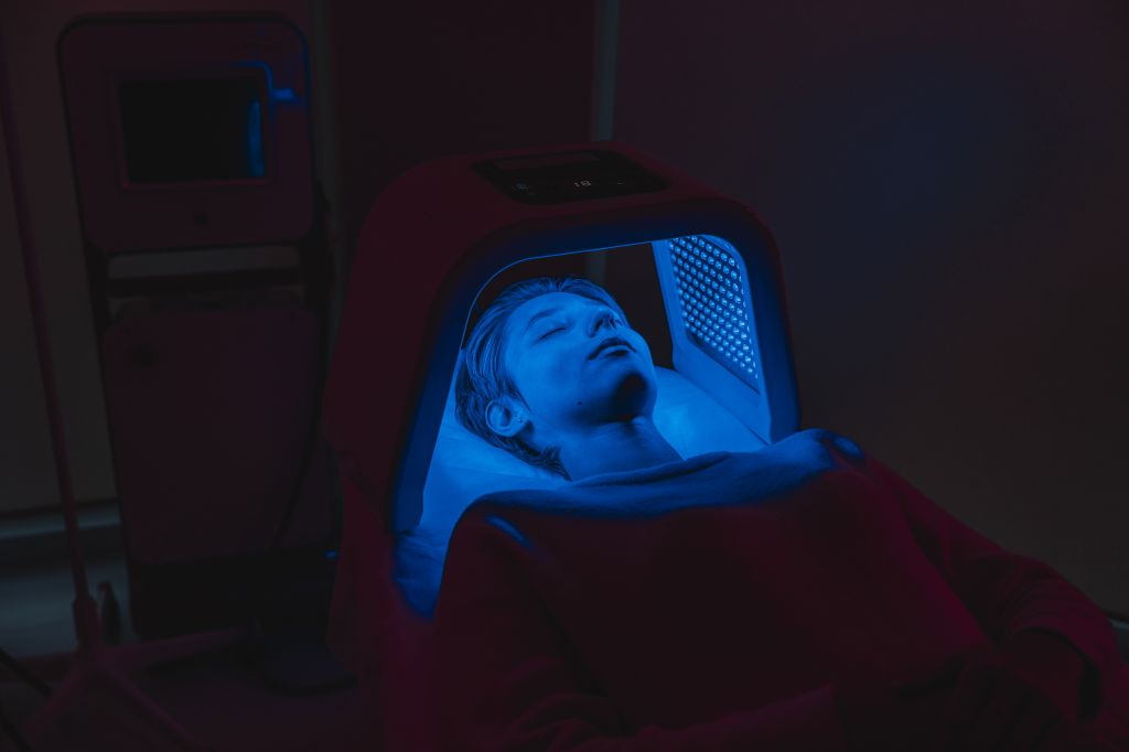 Woman under a blue light lamp