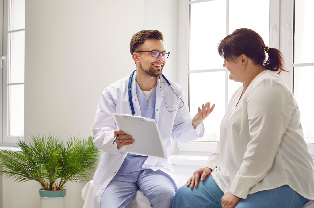 Overweight female talking to a doctor