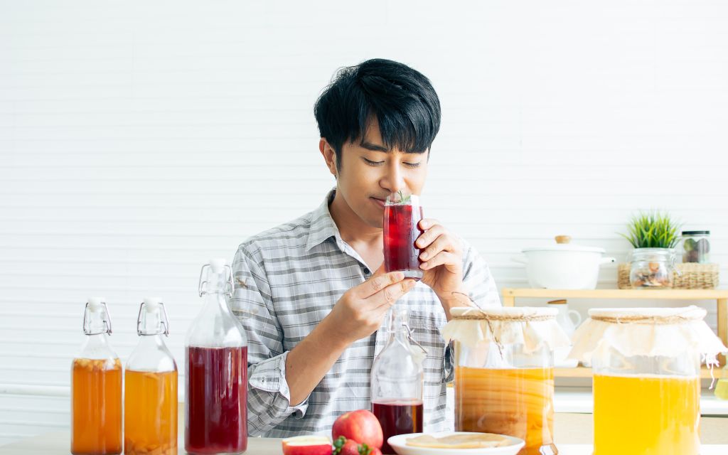 Happy man drinking kombucha