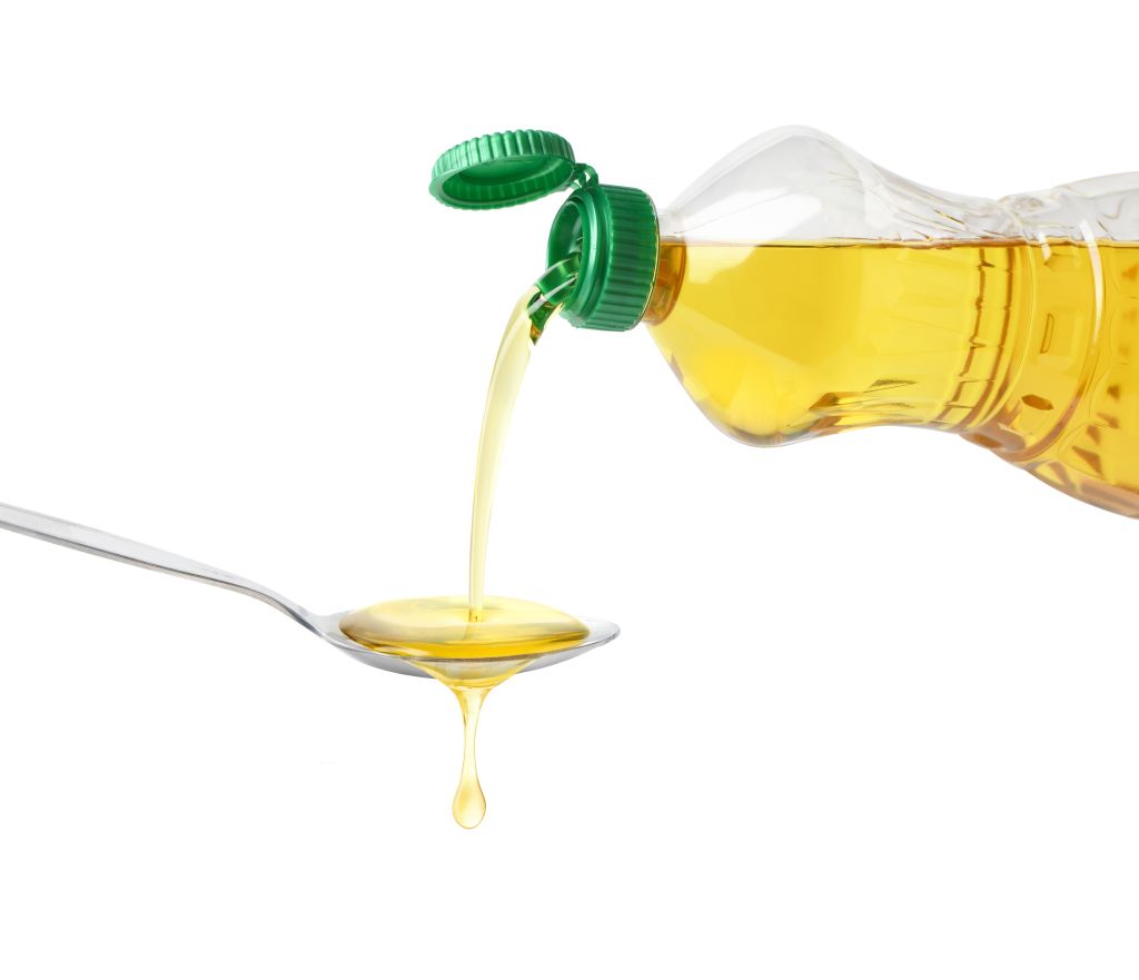 Pouring cooking oil into a spoon 