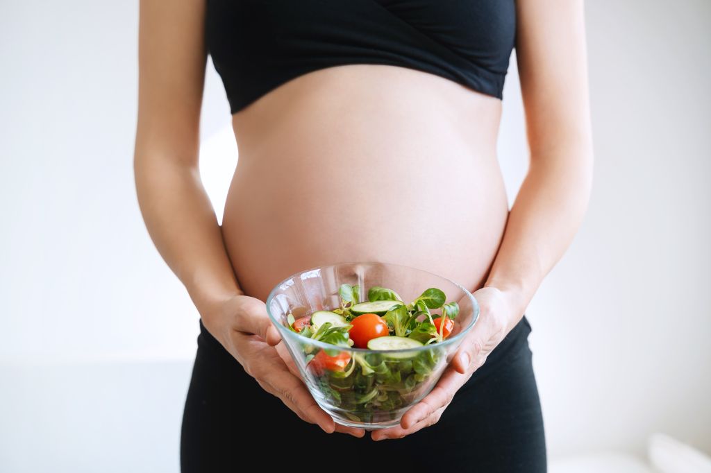 Pregnant woman with folate-rich bowl 