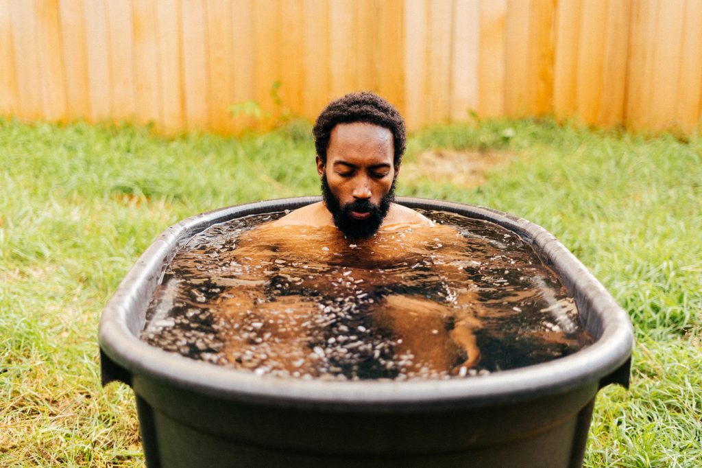 Man taking an ice bath  