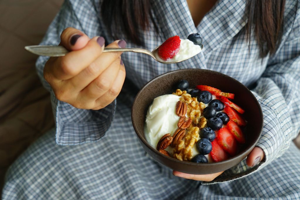 Woman eating a bowl of yogurt 