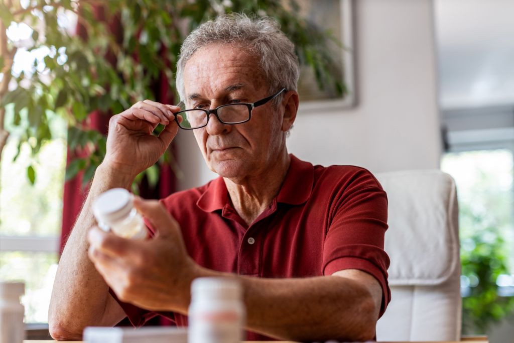 Man reading a supplement bottle