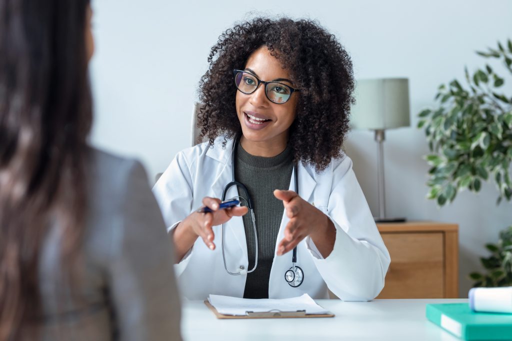 Woman talking to doctor