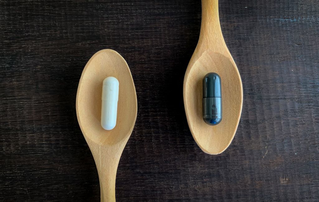 Different pills on wooden spoons