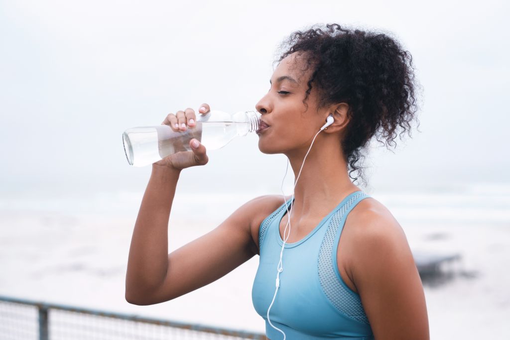 Woman staying hydrated after exercise 