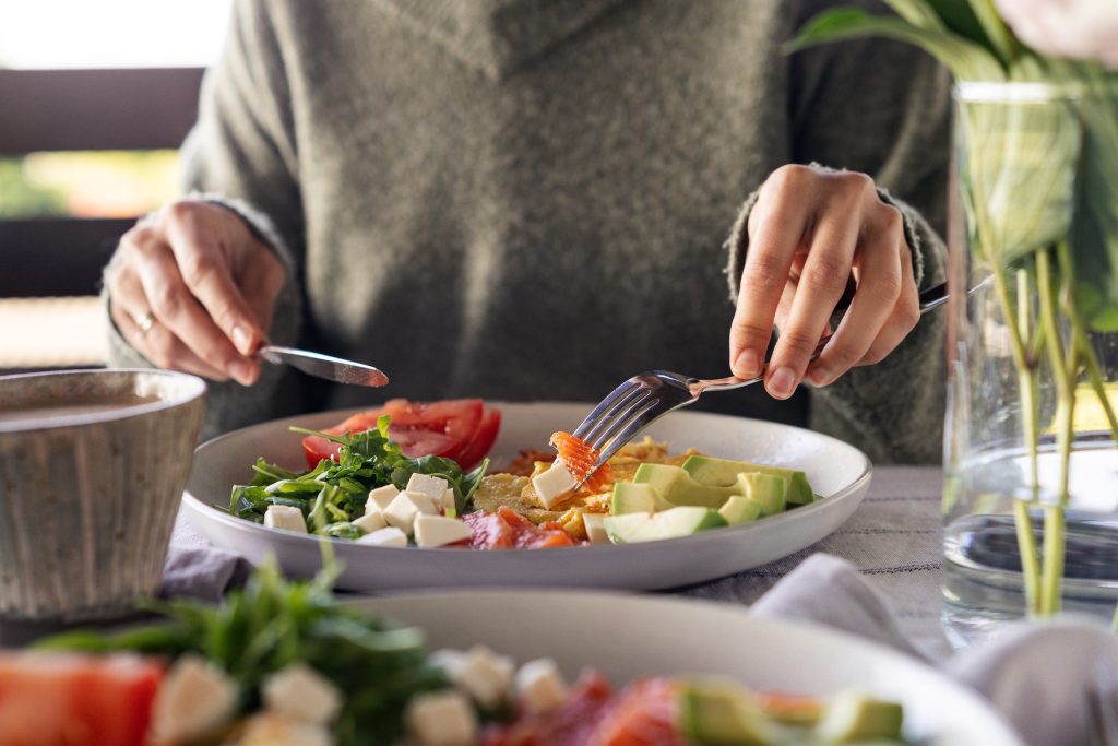 Eating feta-topped keto salad