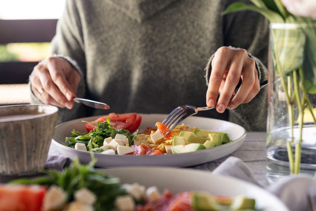 Eating feta-topped keto salad
