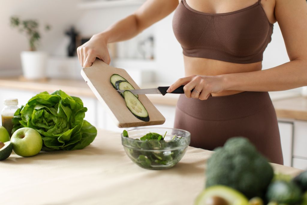 Woman cutting cucumber and the benefits of cucumber