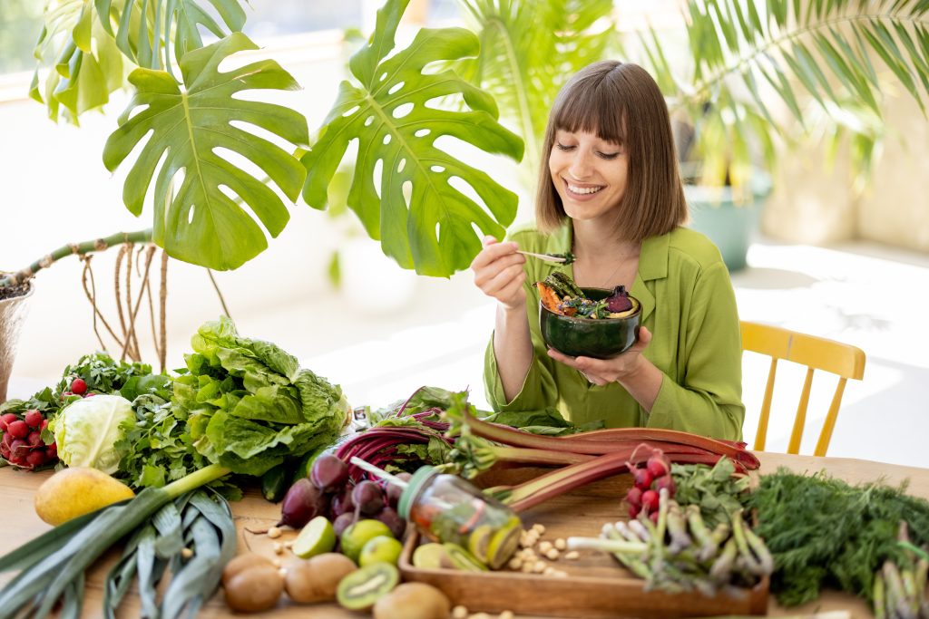 Woman eating leafy greens 