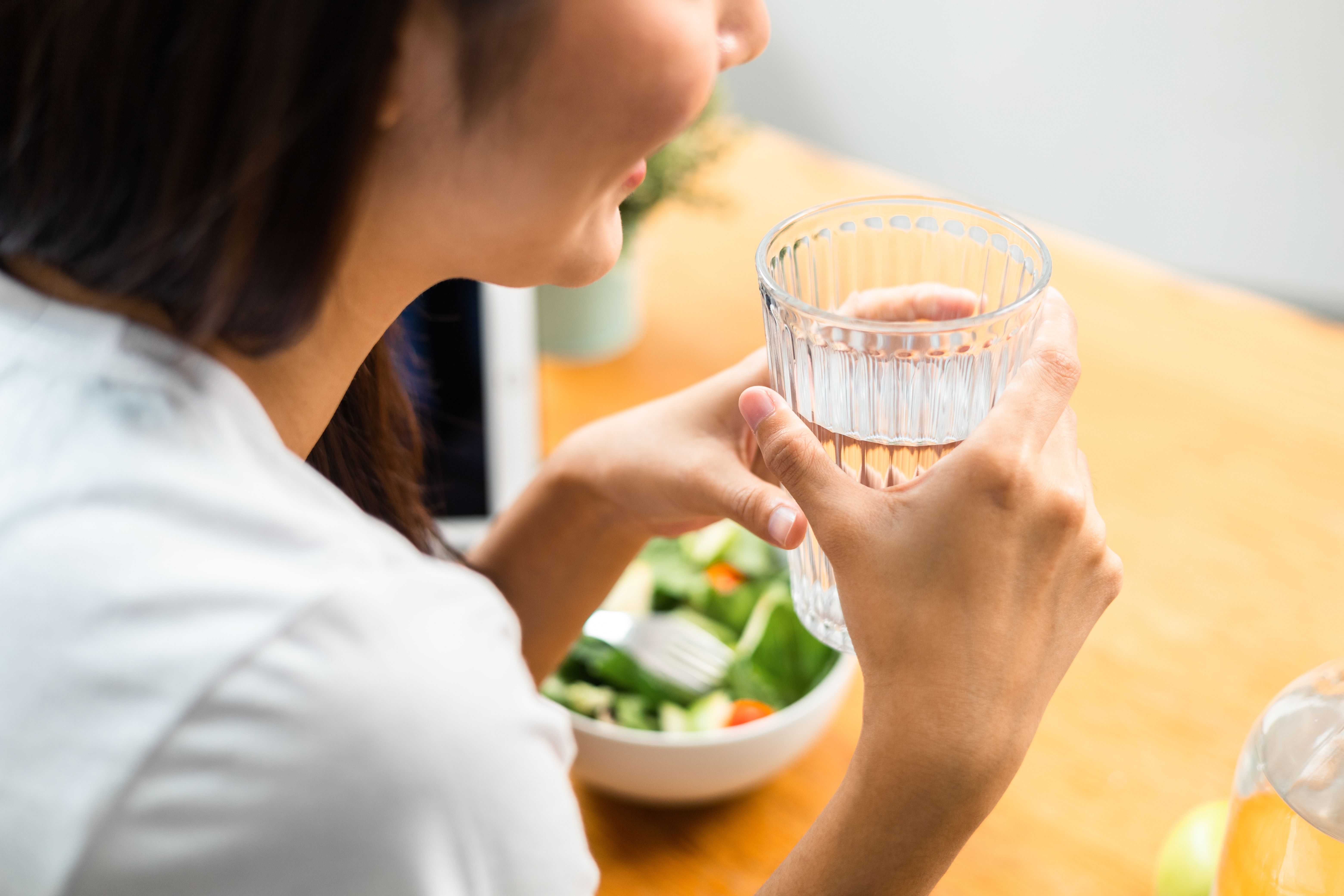 Woman drinking before a meal 