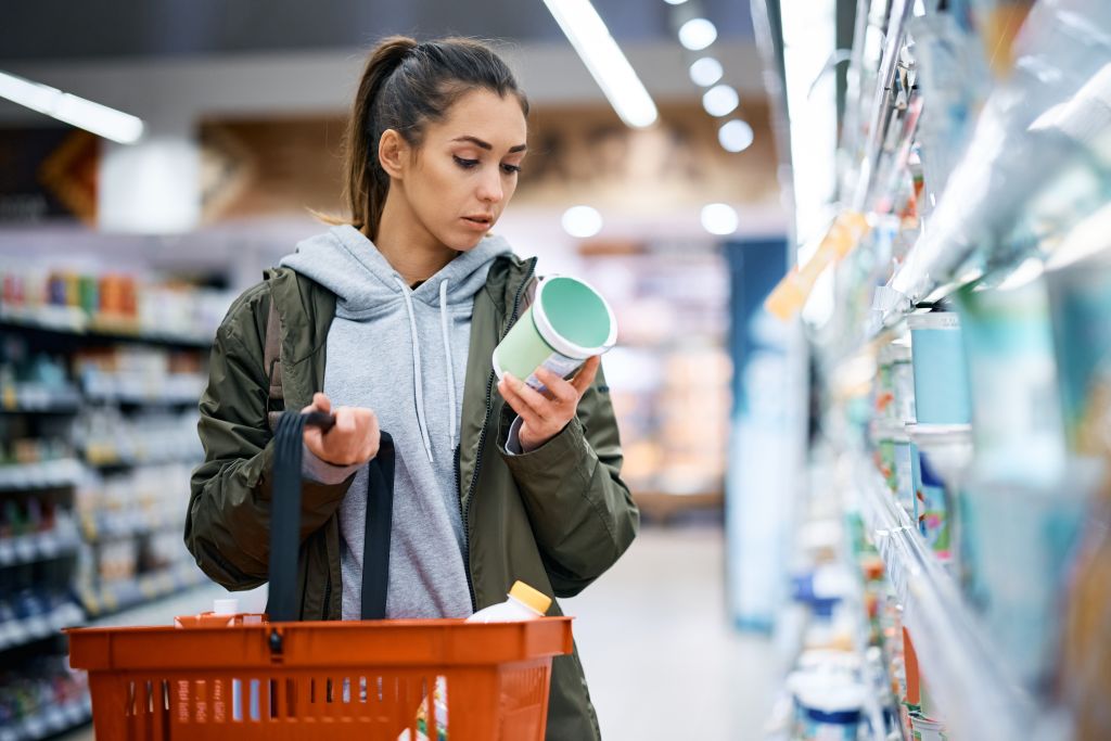 Young woman shopping for yogurt