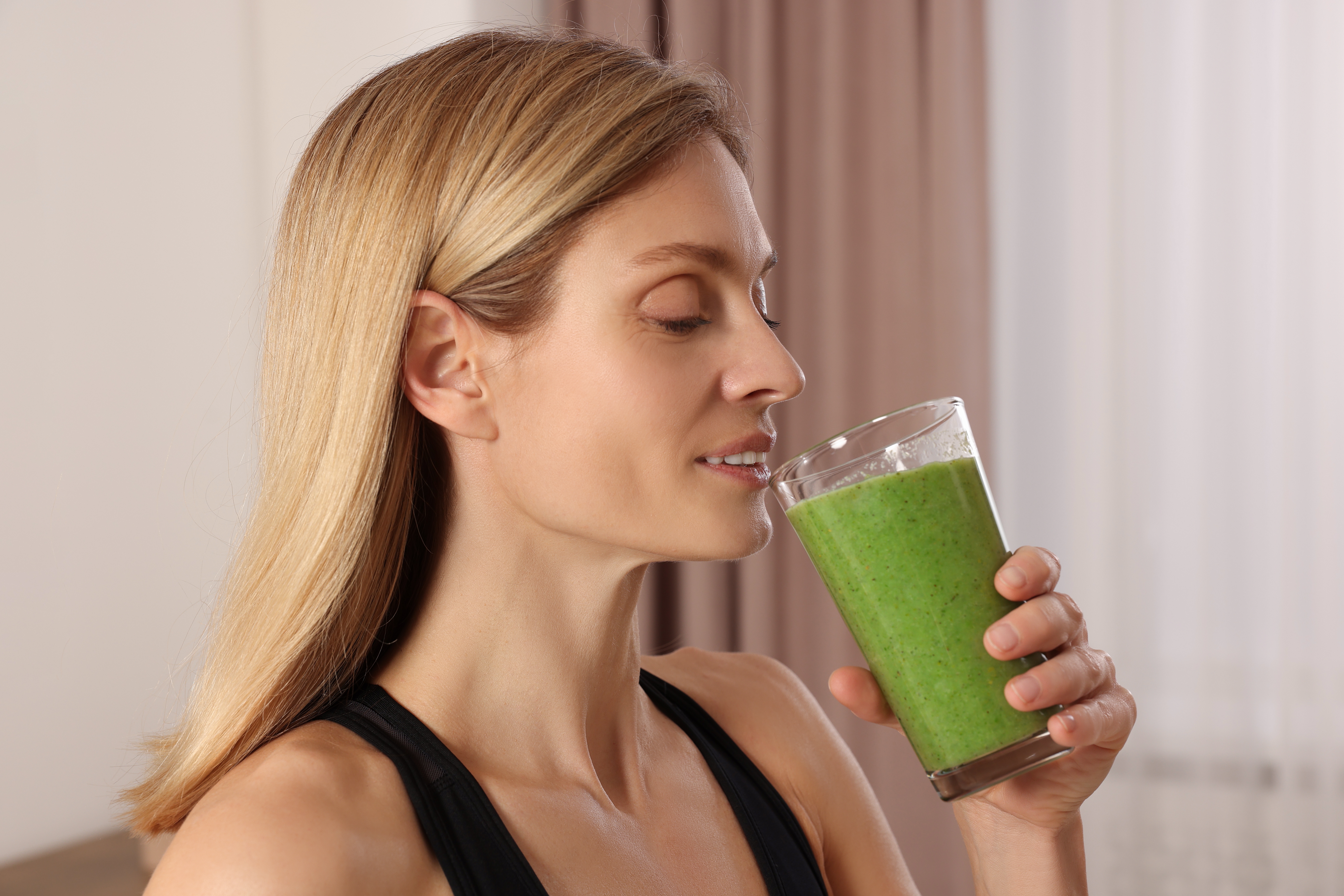 Woman drinking kale shake 