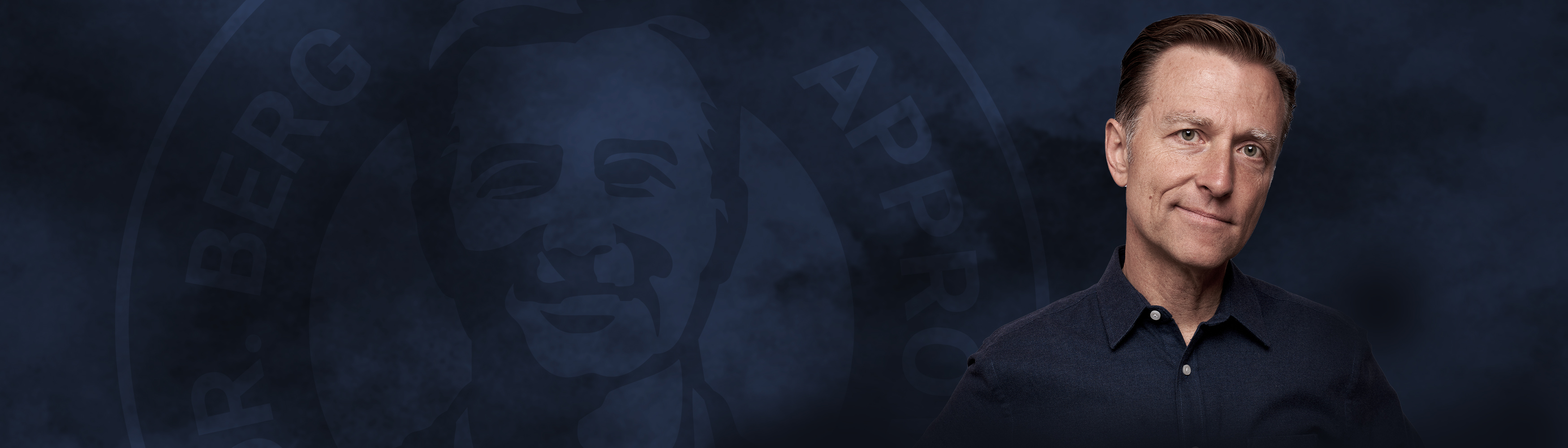 Dr. Berg smiling on a dark background
