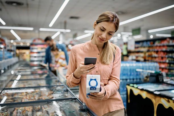 Woman Scanning Code On A Product In Supermarket