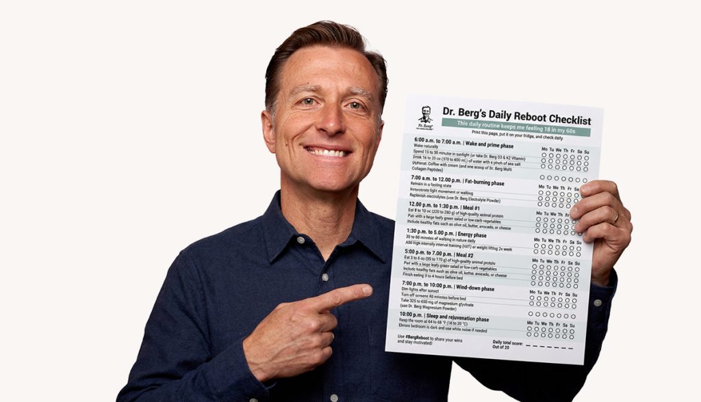 Dr. Berg holding a checklist