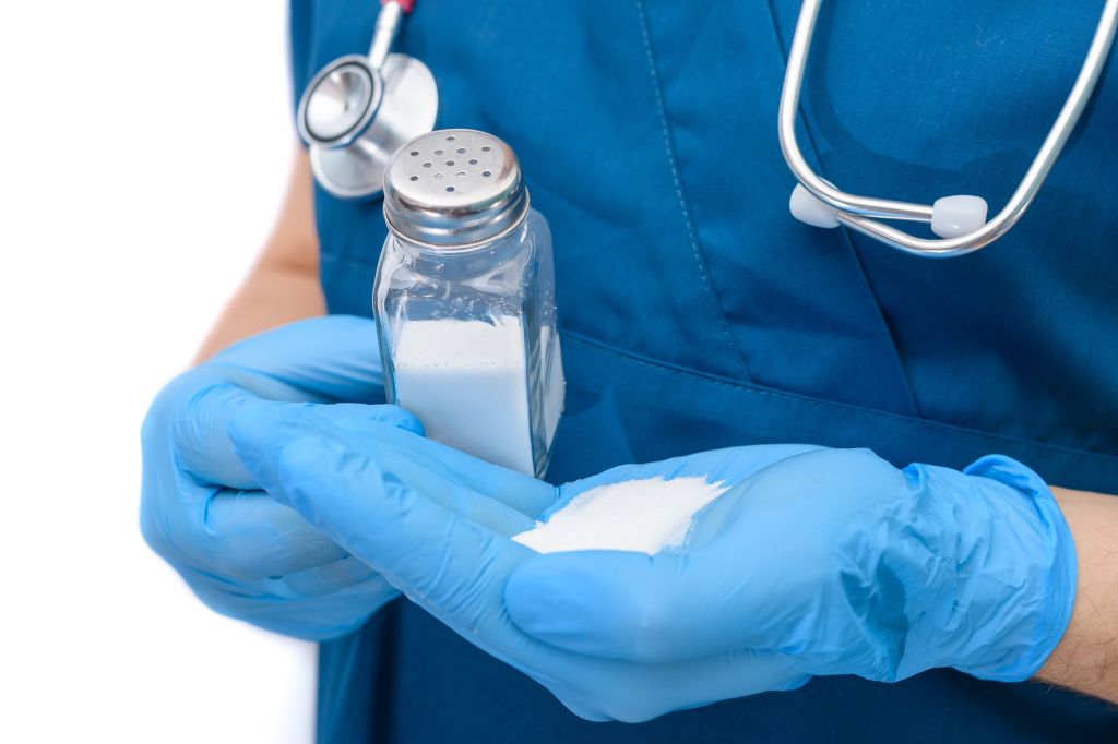 Doctor pours salt on hand 