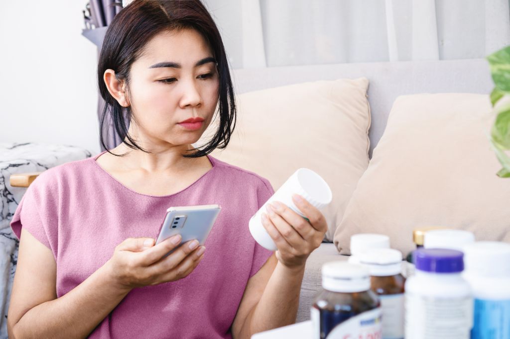 Woman reading supplement labels