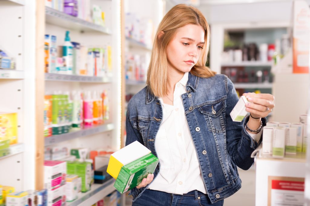 Woman choosing a supplement