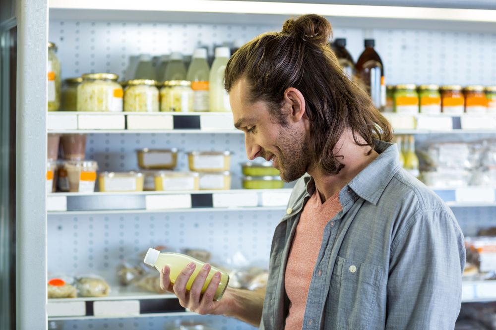 Man reading a beverage label