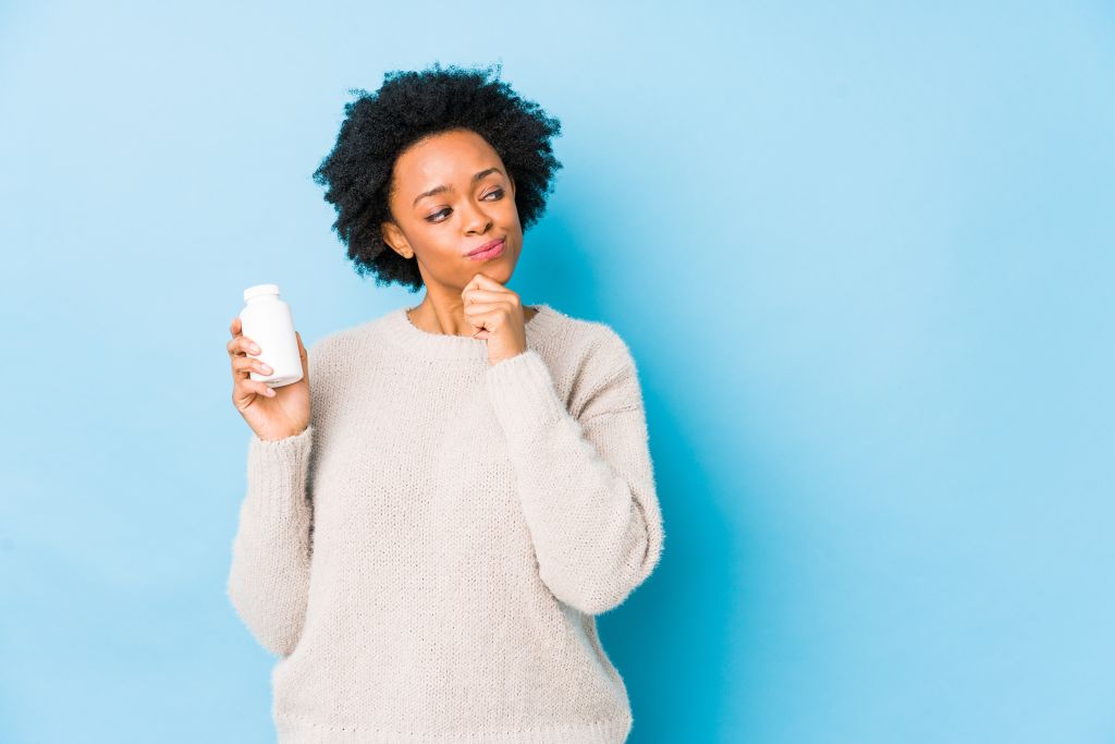 Woman holding a supplement  