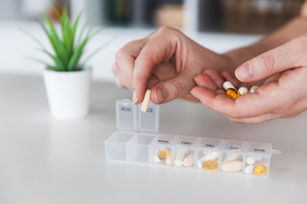 Filling a weekly supplement organizer