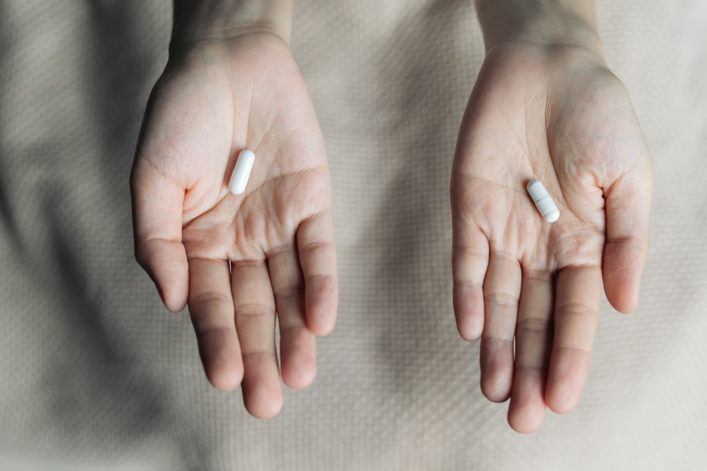 Hands holding supplements 