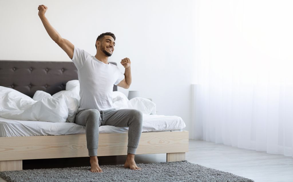 Refreshed man waking up 