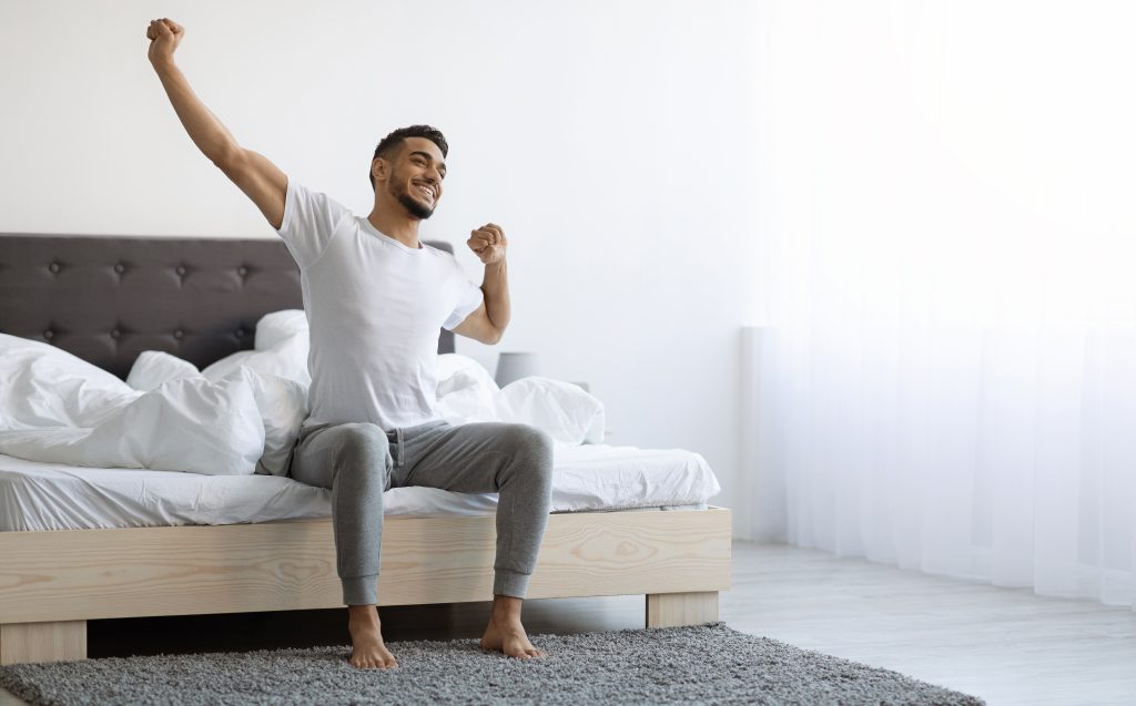 Refreshed man waking up