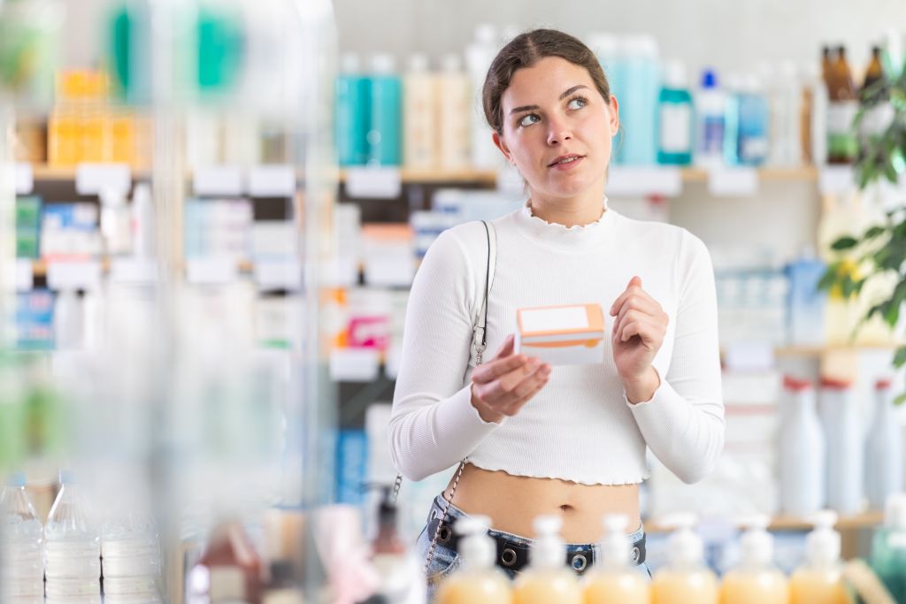 Woman choosing a supplement