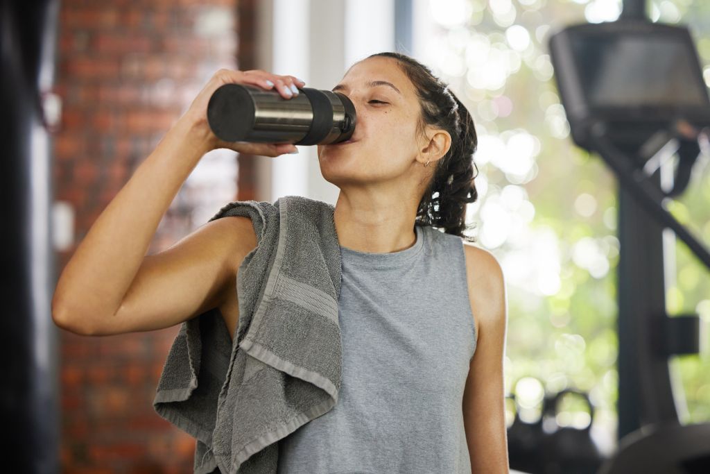 Athletic women drinking from bottle