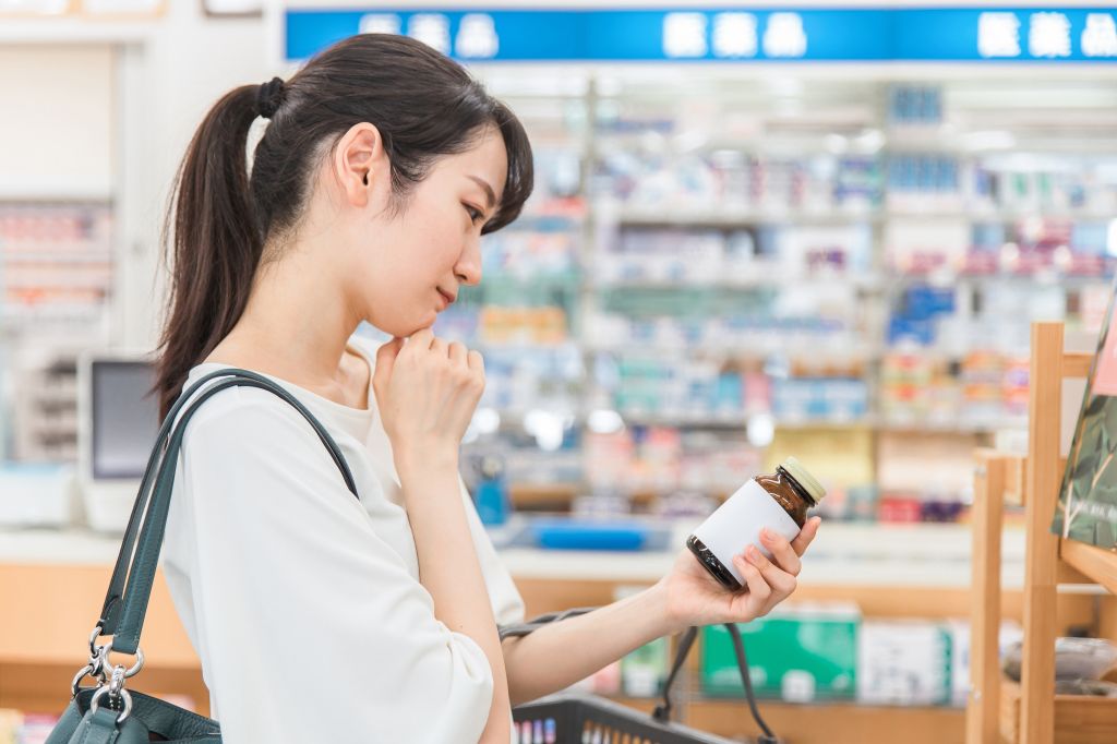 Woman choosing a vitamin B supplement 
