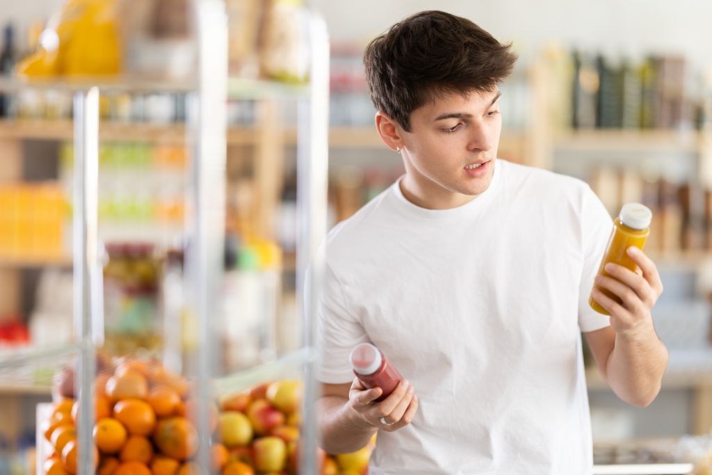 Boy reading beverage nutrition label