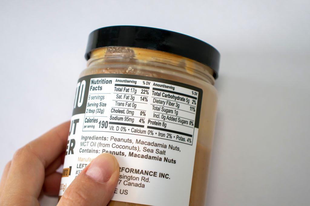 Person inspecting the nutrition and ingredients label