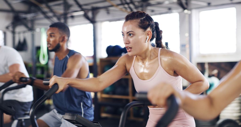 Sweaty woman on exercise bike